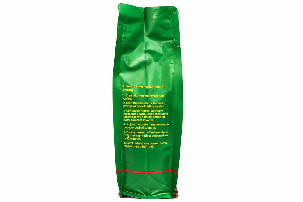A green bag of coffee stands upright against a plain white background, showing printed instructions on the front in yellow and white text.