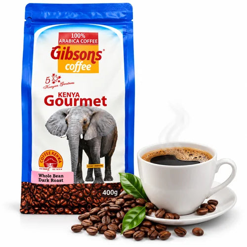 Gibsons Kenya Gourmet Coffee 400g pouch displayed beside a cup of freshly brewed black coffee on a white background featuring 100% Arabica branding Kenyan Greatness elephant artwork Whole Bean Dark Roast label and beans for US shoppers seeking Kenyan coffee. 