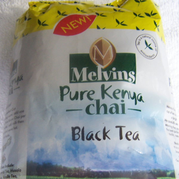 Melvins Pure Kenya Chai Black Tea 250g loose leaf bag close-up front label with red NEW badge and Kenyan tea field design