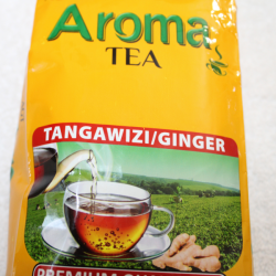 Full front view of yellow Aroma Tea Tangawizi/Ginger 250g bag with cup and ginger imagery