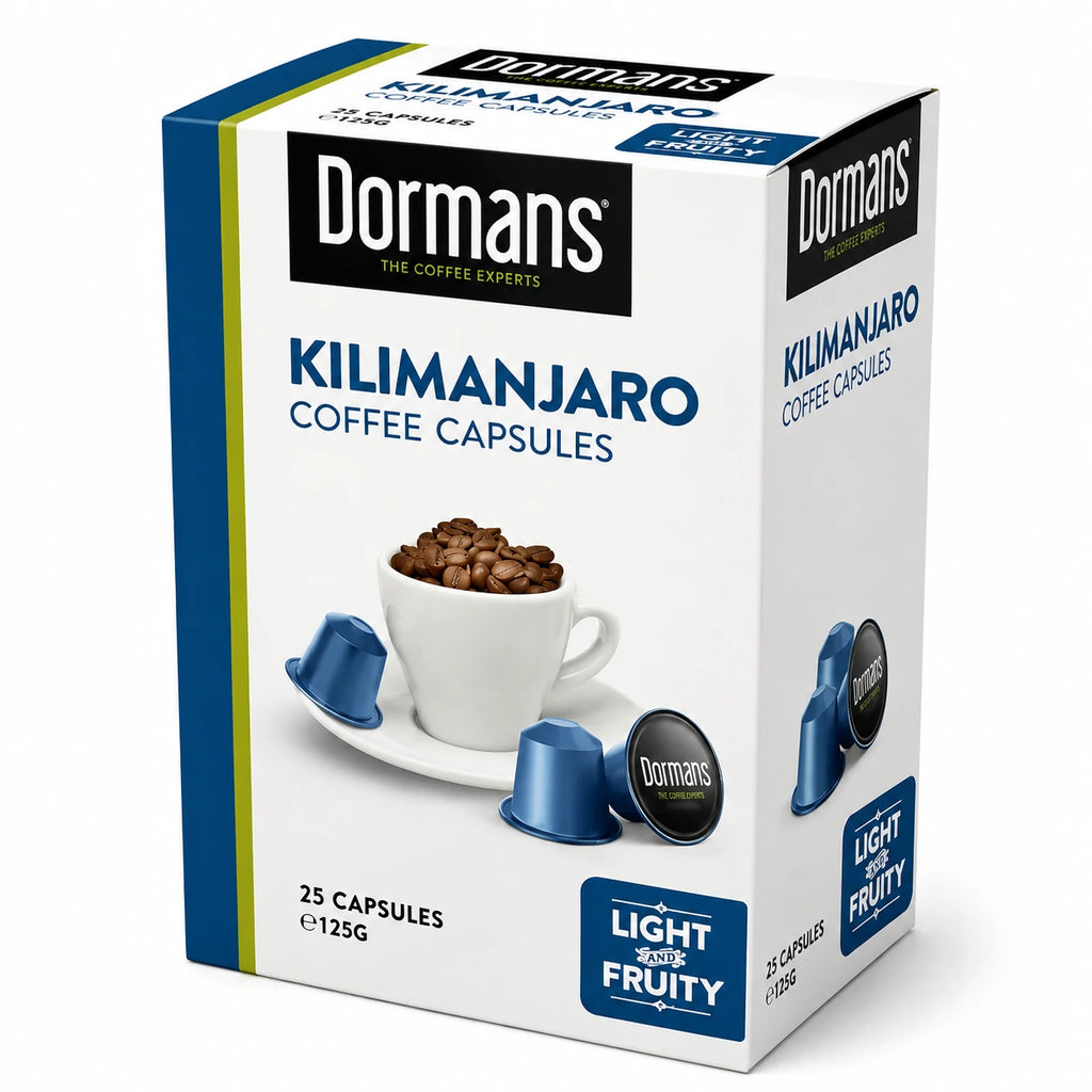 Dormans Suprema Zesty and Complex Coffee Capsules 25 pack with medium roast Kenyan coffee and a distinctive flavor profile featuring bright citrus notes, subtle chocolate character, and delicate maple-like sweetness. The retail box has white and gold Dormans packaging with clearly visible Suprema Coffee Capsules branding, Zesty and Complex label, coffee beans, coffee cup, and metallic capsule imagery. This single-serve coffee capsule format is designed for compatible espresso coffee machines and convenient 