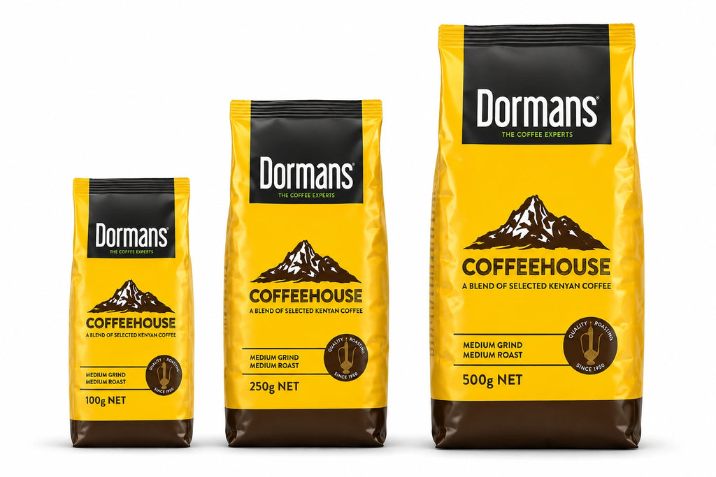 Dormans Coffee House Medium Roast Medium Grind 100g Kenyan ground coffee pouch by Dormans, featuring yellow and dark brown packaging, Coffeehouse branding, selected Kenyan coffee, medium roast, medium grind and 100g net weight, presented as a realistic three-dimensional product image on a clean white background for World Safari Shops.
