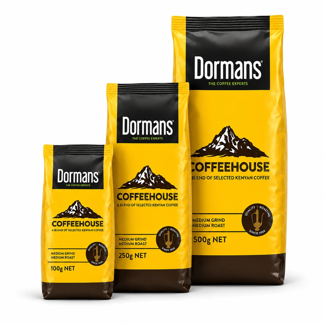 Dormans Coffeehouse Kenyan Coffee packaging range showing three yellow and brown coffee pouches arranged from smallest to largest, with the smallest 100g package, middle 250g package and largest 500g package, featuring Dormans Coffee Experts branding, Coffeehouse mountain artwork, A Blend of Selected Kenyan Coffee, medium grind, medium roast and Quality Roasting Since 1950 emblems, presented on a clean white background for World Safari Shops Shopify product photography.