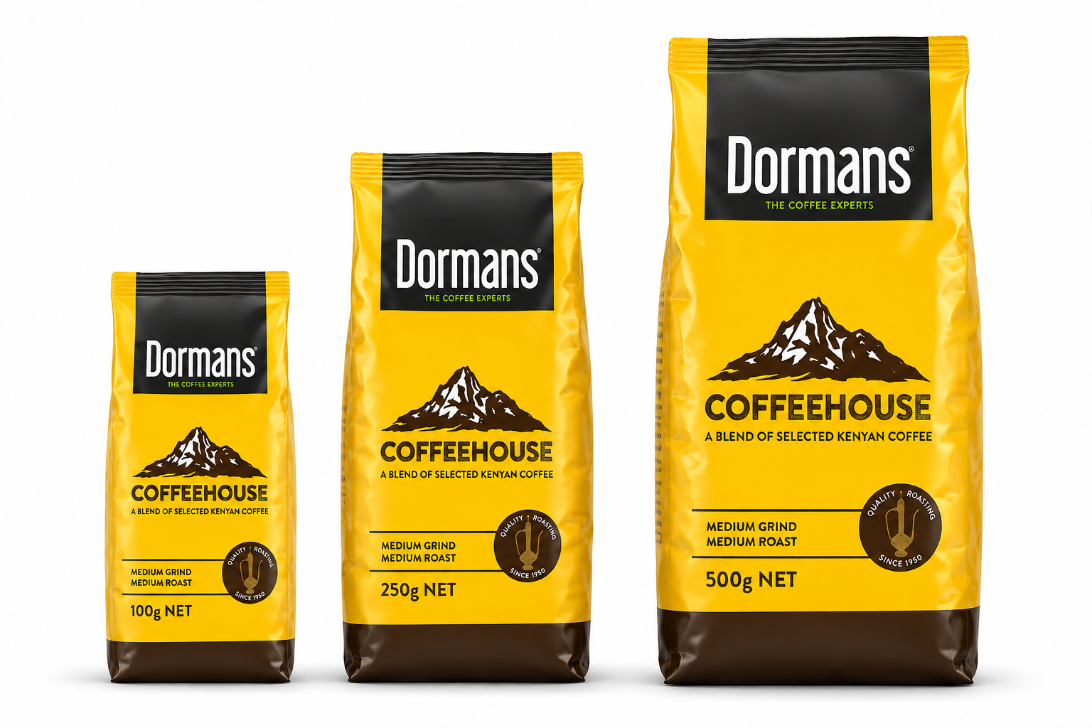 Dormans Coffeehouse Kenyan Coffee packaging range showing three yellow and brown coffee pouches arranged by size, with the smallest 100g package in front, the middle 250g package and the largest 500g package, featuring Dormans Coffee Experts branding, Coffeehouse mountain artwork, A Blend of Selected Kenyan Coffee labeling, medium grind, medium roast and Quality Roasting Since 1950 emblems, presented as a realistic three-dimensional product range image for World Safari Shops.