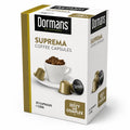 Dormans Suprema Zesty and Complex Capsules 25, medium roast Kenyan coffee capsules in a convenient single-serve format, featuring Dormans Coffee Experts branding, white and gold packaging, Zesty and Complex flavor profile, coffee cup, roasted coffee beans, and metallic coffee capsules. The 25-capsule package is designed for espresso preparation using a compatible capsule coffee machine and provides a convenient way to enjoy Kenyan coffee at home, in the office, or as part of an everyday espresso coffee rout