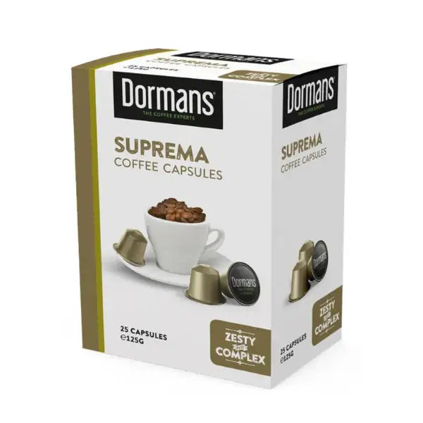 Dormans Suprema Zesty and Complex Capsules 25 pack featuring Kenyan medium roast coffee capsules with bright citrus notes, subtle chocolate character, and delicate maple-like sweetness. The product packaging is predominantly white and gold with visible Dormans branding, Suprema Coffee Capsules labeling, Zesty and Complex badge, coffee cup, roasted coffee beans, and capsule imagery. Designed for single-serve espresso preparation, these coffee capsules are suitable for compatible coffee capsule machines at ho