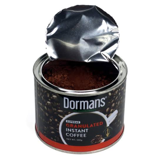 Dormans Supreme Granulated Instant Coffee 100g shown in an opened coffee can with granulated instant coffee visible inside, featuring Dormans branding, Kenyan coffee, Kenyan instant coffee, premium instant coffee, granulated coffee, coffee granules, and convenient 100g coffee packaging for home, office, travel, and everyday coffee preparation.