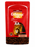 A red stand-up pouch of Gibson's Coffee Kenya AA whole bean dark roast coffee, featuring a lion graphic and a clear window at the bottom showing roasted coffee beans.