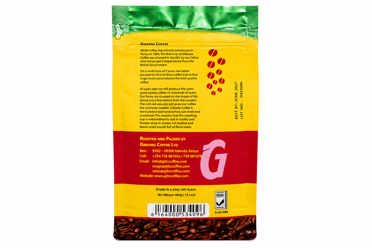 Back view of a roasted coffee bag from Gibsons co., featuring a yellow and red label with product details, a barcode, and visible coffee beans at the bottom. Gibsons Kenya coffee beans in whole bean form, Kenya Household blend with mild soft taste and medium roast 400g