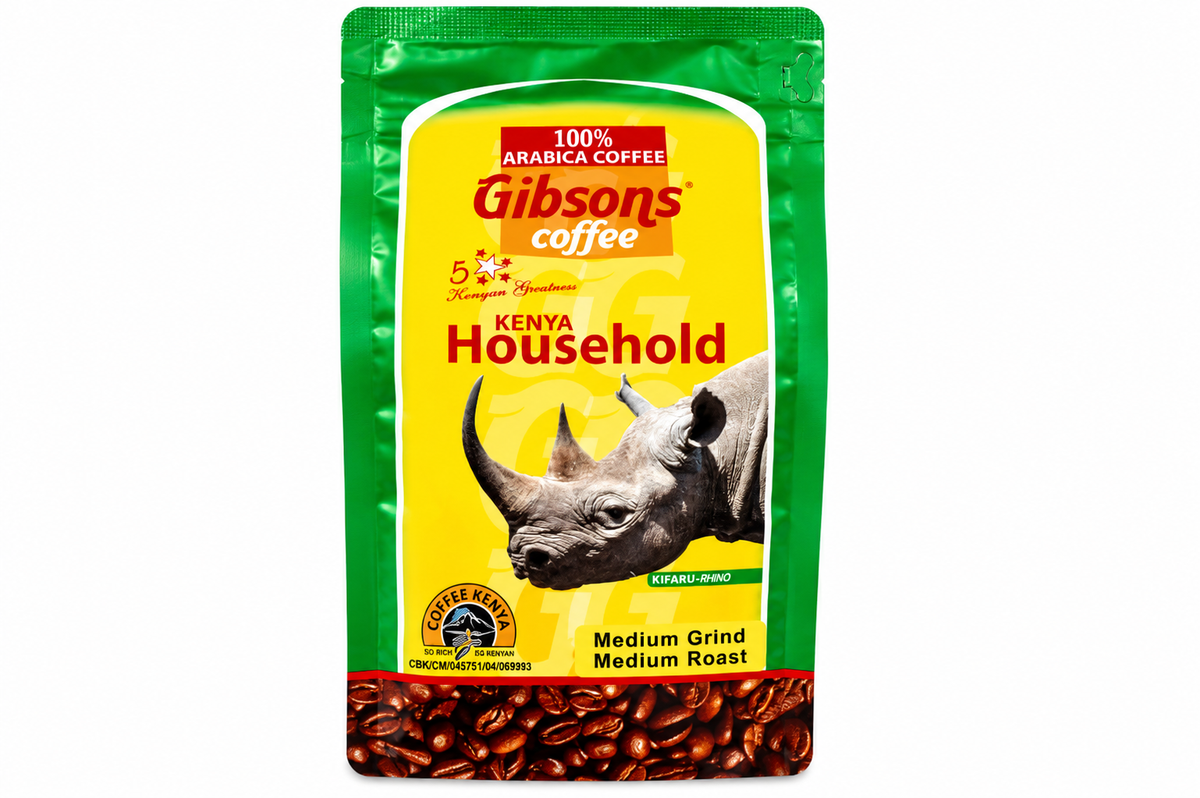 A bag of Gibson's Coffee Kenya Household medium roast coffee beans, featuring a green and yellow package with a rhinoceros graphic and a band of coffee beans at the bottom. Gibsons Kenya Medium Ground Coffee 400g, Kenya Household blend made from 100% Arabica Kenyan coffee, medium roast ground coffee.