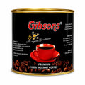 Gibsons Premium 100% Instant Coffee canister featuring the black and gold Gibson's packaging, Kenyan Greatness branding, red coffee cup graphic, roasted coffee beans, and premium instant coffee labeling, presented upright on a clean white background. The product image clearly shows the cylindrical coffee tin, gold rim, black label, red Gibsons logo, five-star Kenyan Greatness design, coffee cup illustration, and 100% instant coffee wording for an accurate Shopify product listing and accessible Google Images