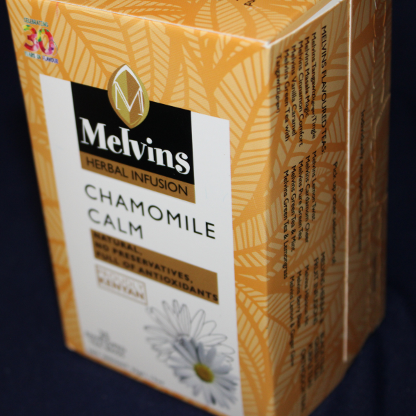 Close-up front angle of Melvins Chamomile Calm herbal tea box with chamomile flower artwork
