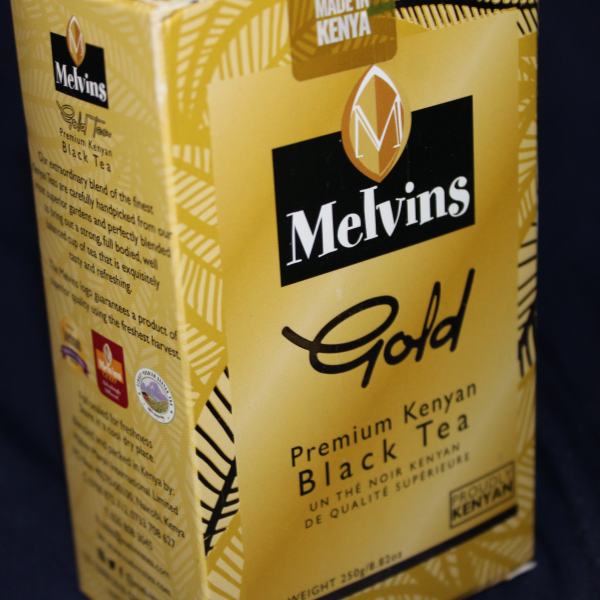  Close-up front of Melvins Gold box showing brand name, "Premium Kenyan Black Tea" label, gold leaf design, and "Made in Kenya" badge at top