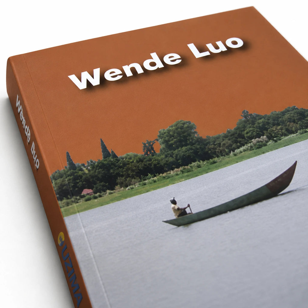Wende Luo Dholuo Hymnal Kenyan Christian book and Luo worship songbook, featuring the brown-orange Wende Luo cover, river canoe scene, green shoreline, and blue UZIMA spine, available from World Safari Shops.