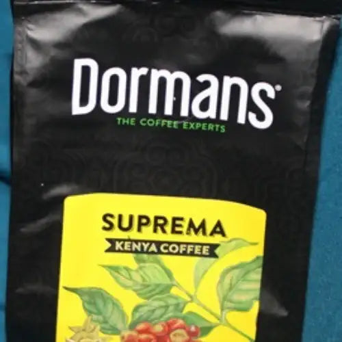 Medium roast medium grind ground coffee from Dormans Suprema, a 375g Kenyan coffee with bright citrus flavor, subtle chocolate notes, sweet maple-like aroma, balanced acidity, and smooth body. Dormans SUPREMA Kenya Coffee - Medium Roast Medium Grind 375g - World Safari Shops.